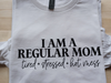 White long sleeve tee with "I am a Regular Mom, tired, stressed, hot mess" printed on front.