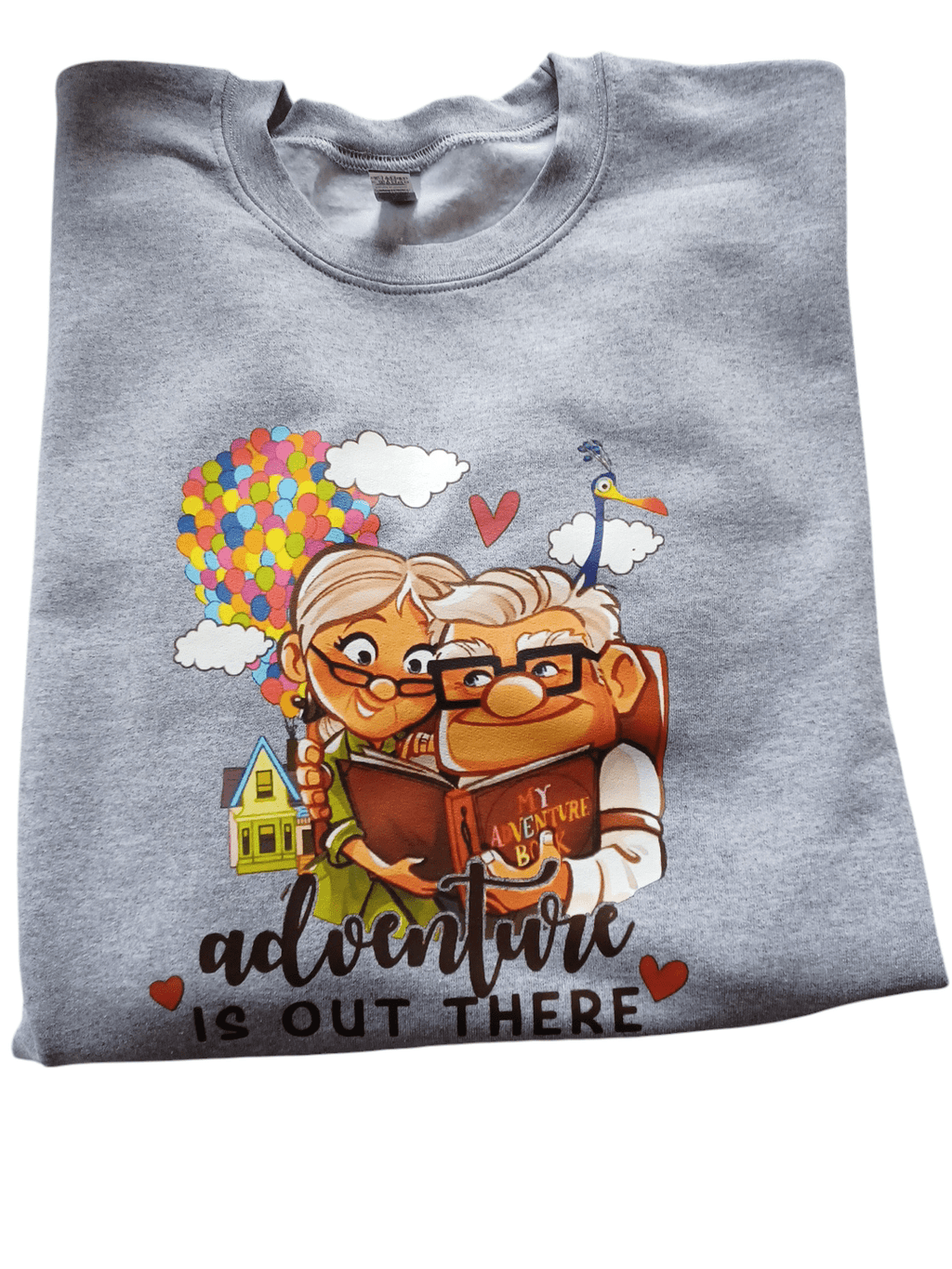 Grey crewneck sweatshirt with colorful "Adventure is out there" print from movie Up featuring cartoon couple Doug and his wife