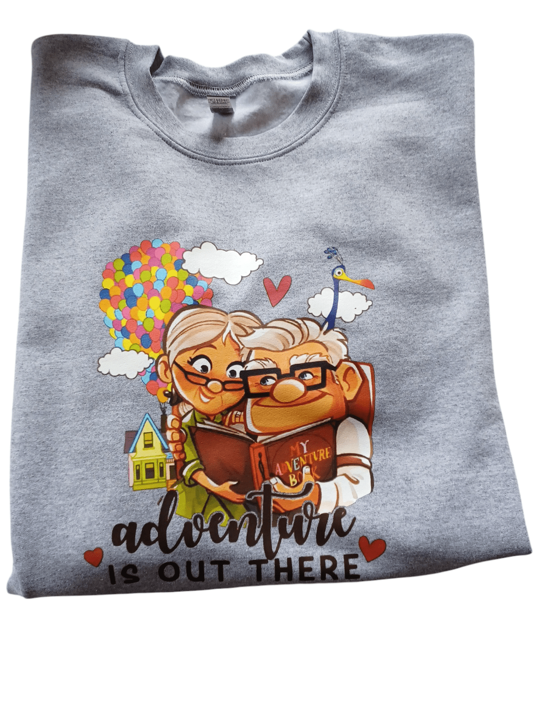 Grey crewneck sweatshirt with colorful "Adventure is out there" print from movie Up featuring cartoon couple Doug and his wife