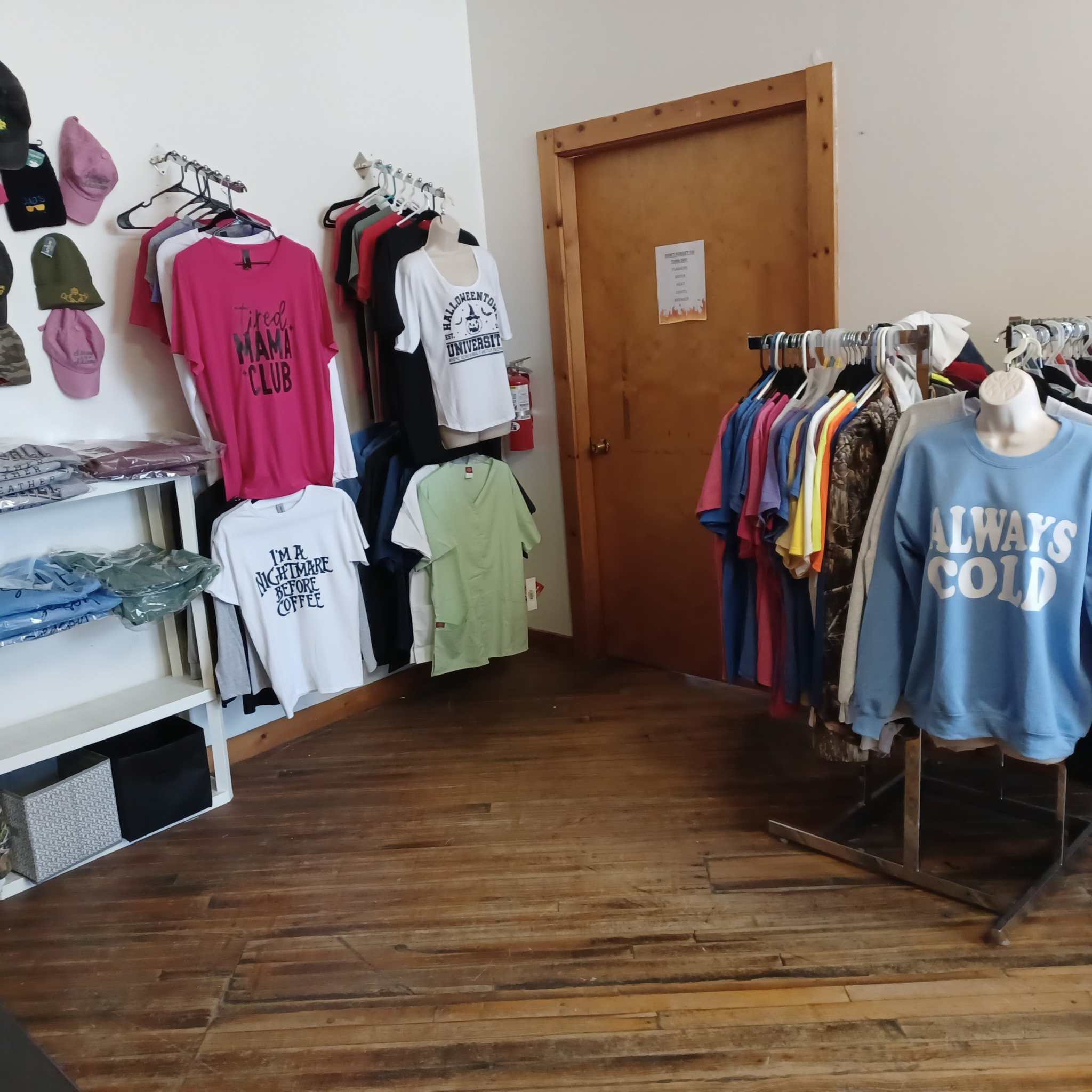 Blue cotton crewneck sweatshirt with Always Cold logo displayed in clothing store