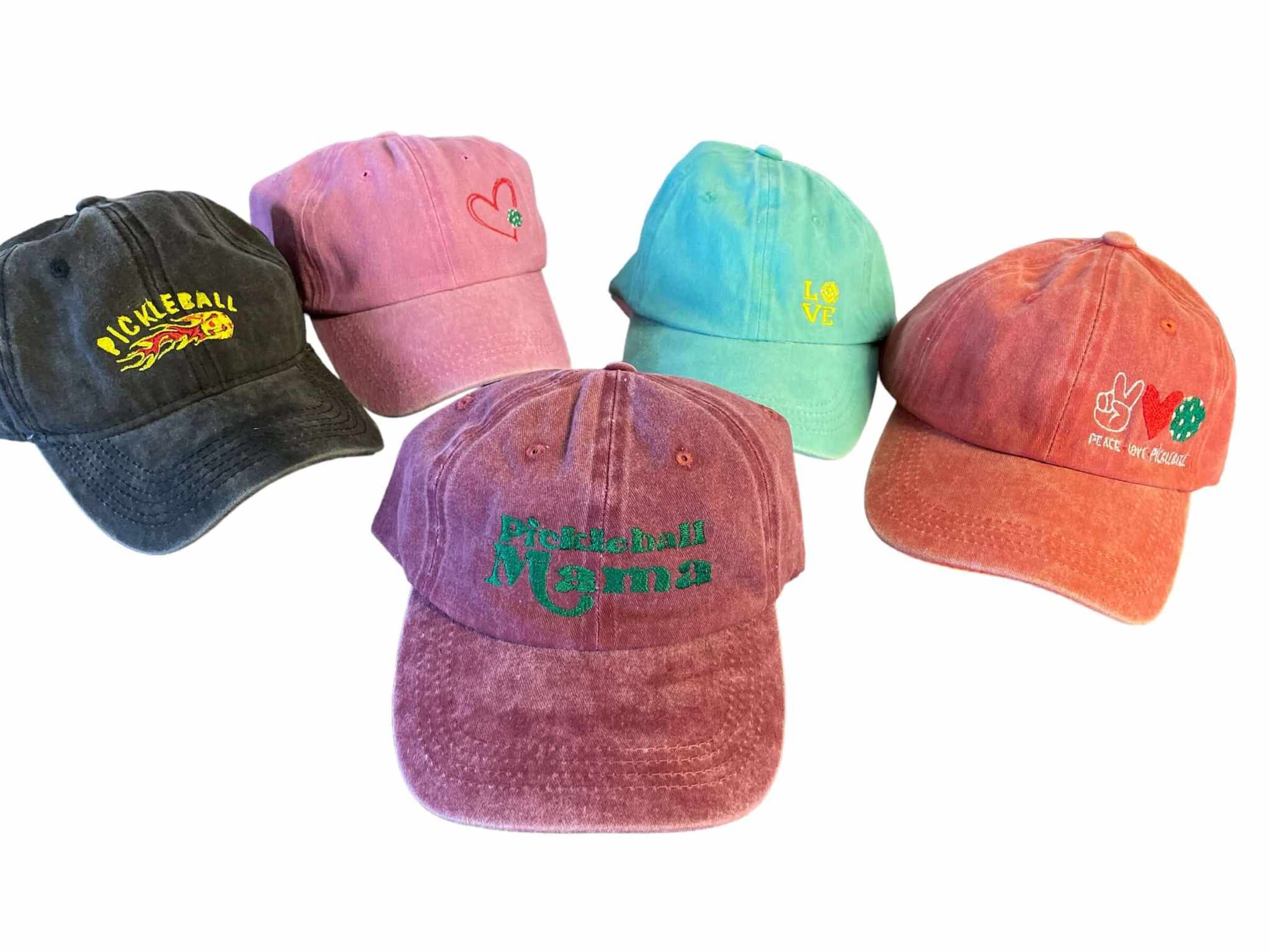 Set of five colorful embroidered pickleball hats with various slogans including Pickleball flames, heart, love, Pickleball Mama, and peace signs