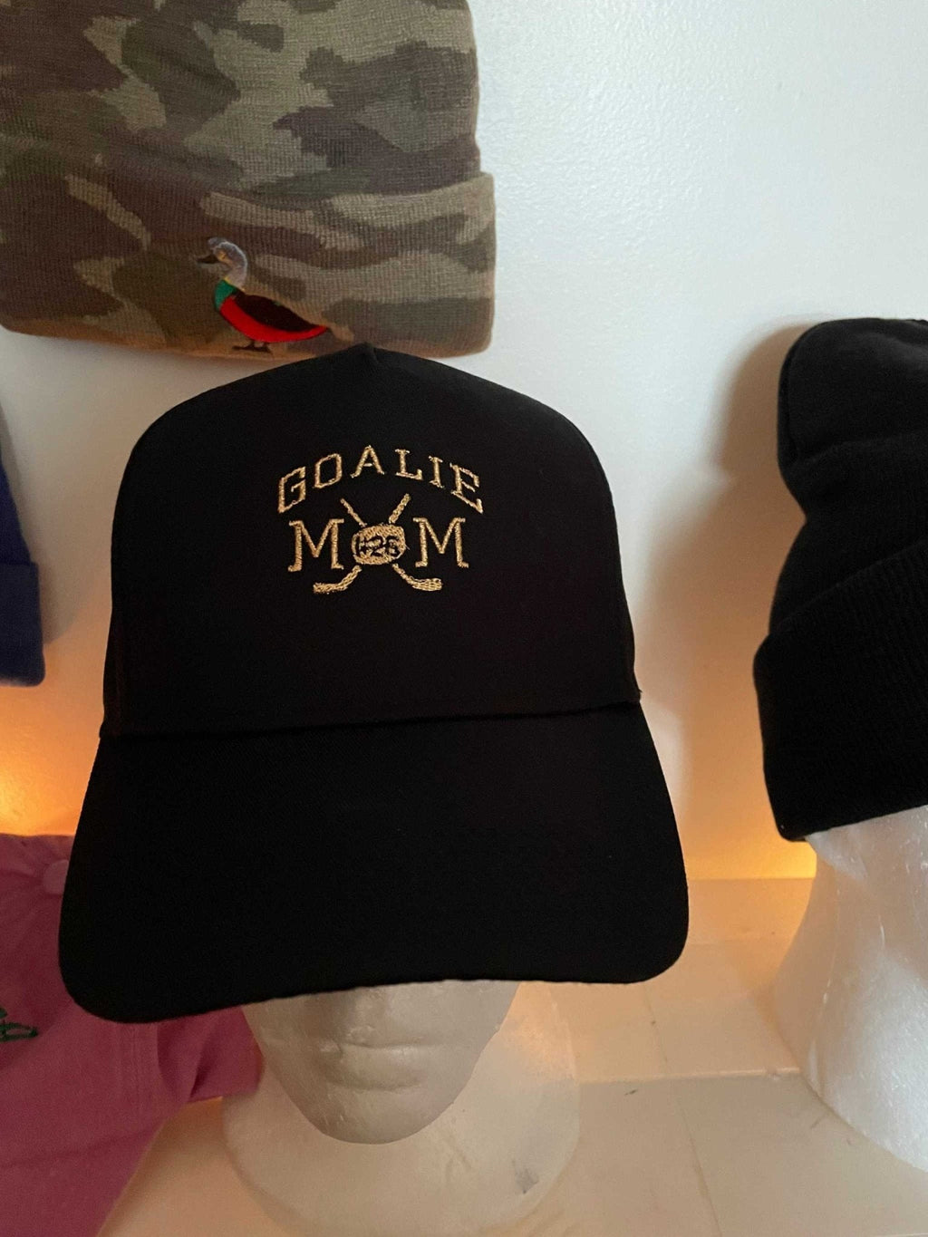Black baseball hat with embroidered Goalie Mom and hockey design, personalized for hockey mom fans.
