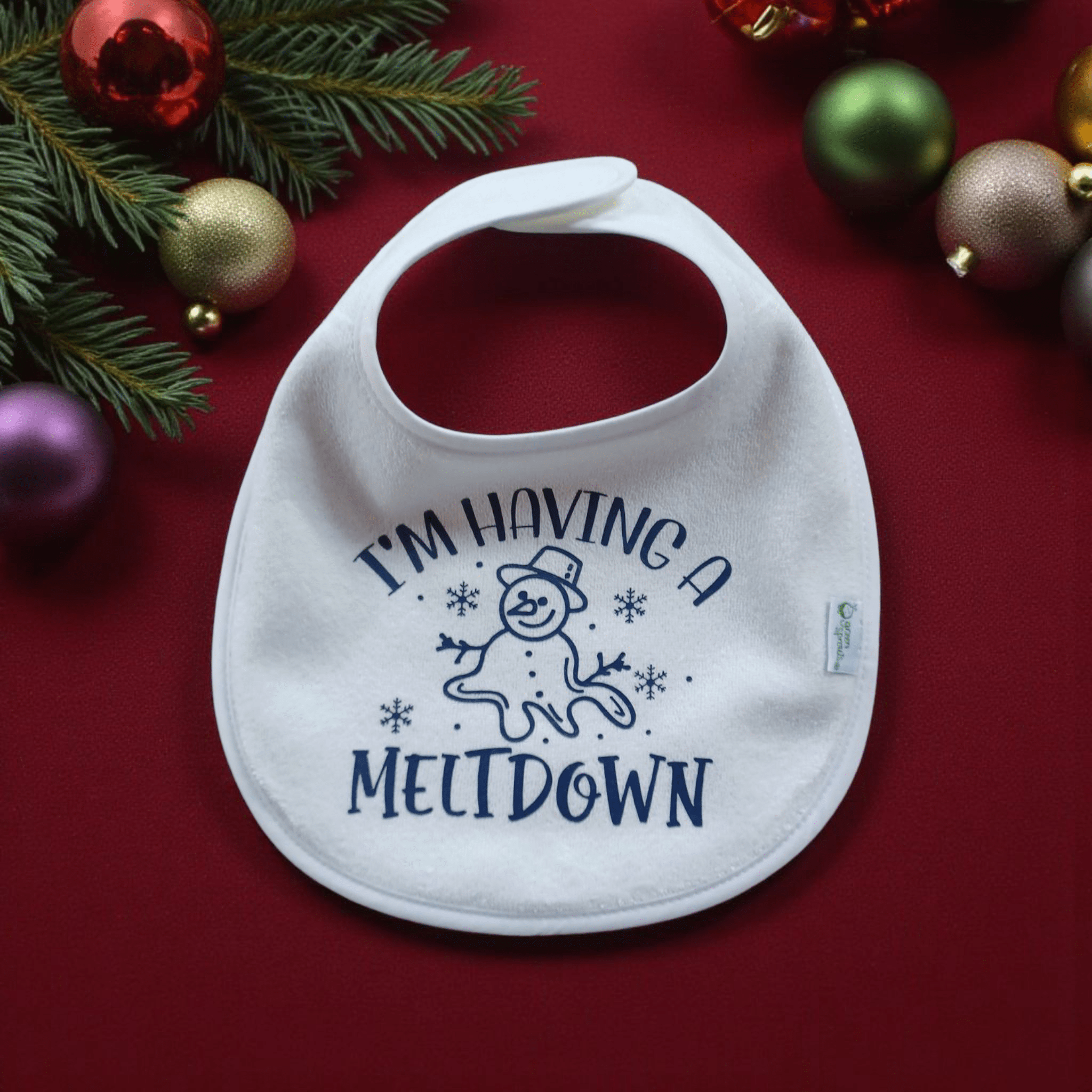 Holiday Baby Bib with "I'm Having a Meltdown" snowman design on festive background