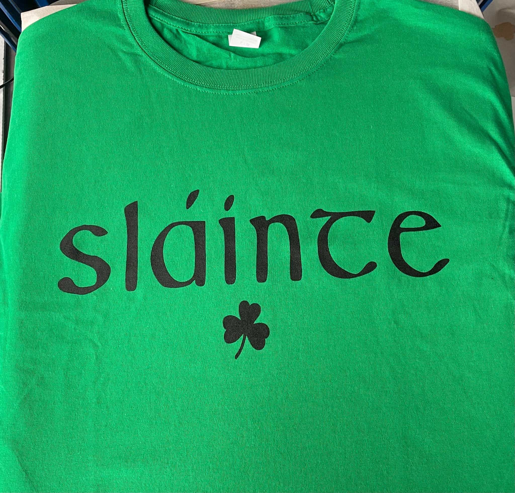 Green cotton t-shirt with black "sláinte" text and shamrock design