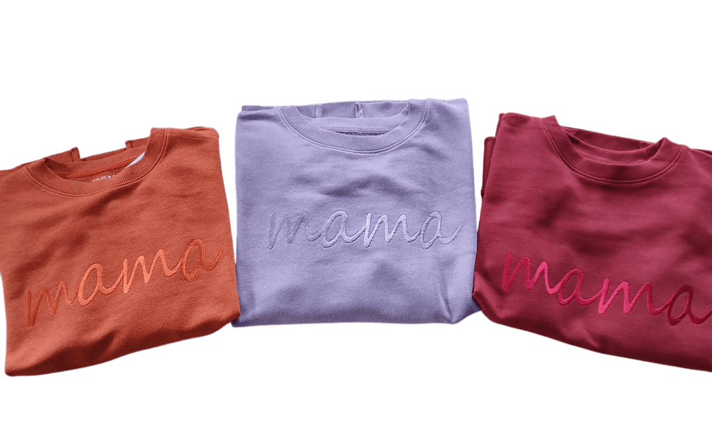Mama embroidered relaxed fit cotton sweaters in rust orange, lavender, and deep red colors