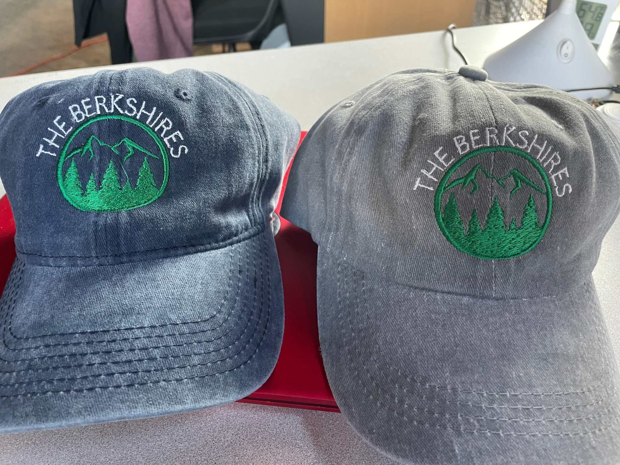 Two adjustable Berkshires baseball hats in denim blue and gray with embroidered mountain logo
