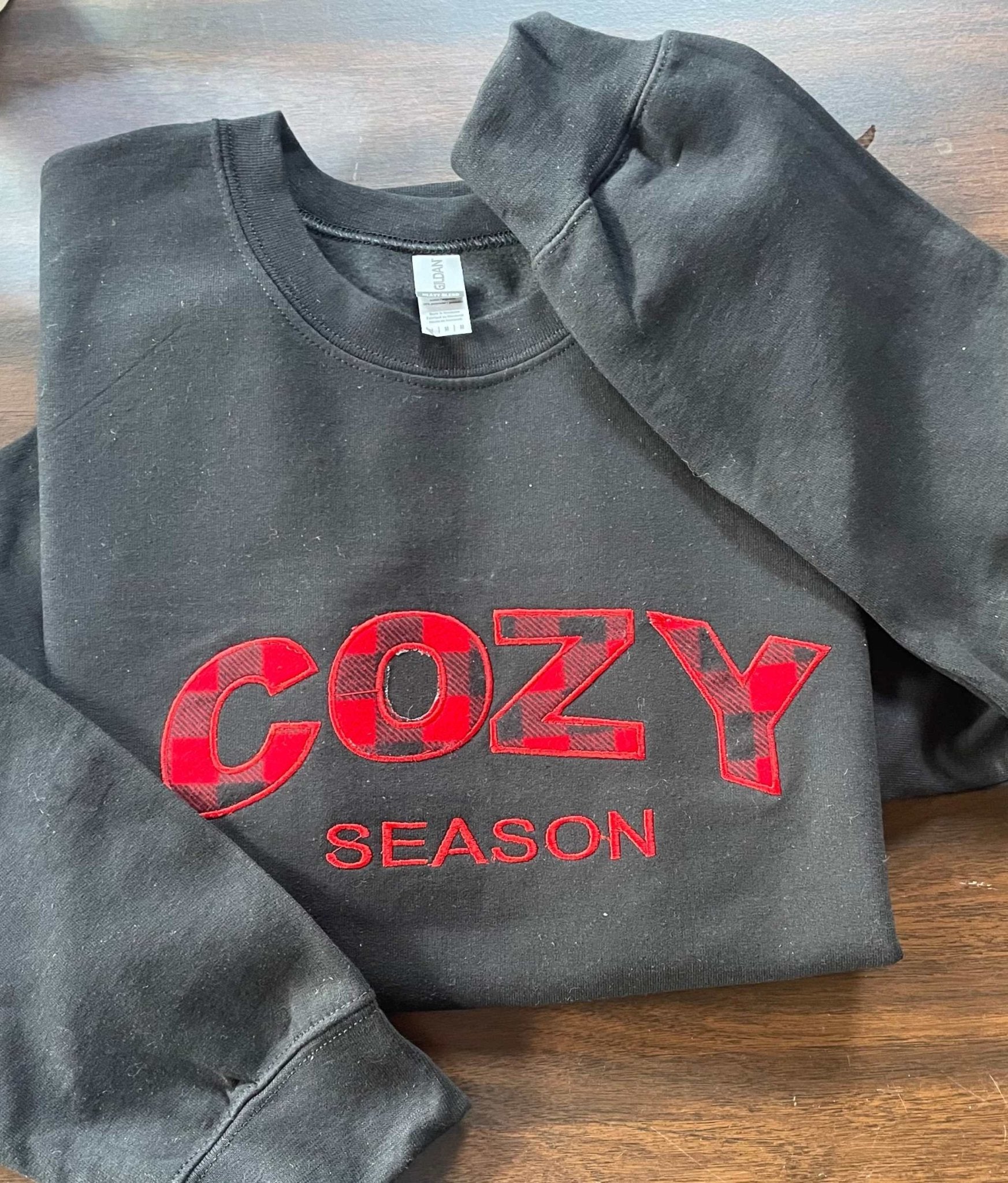 black Cozy Season Crewneck sweatshirt with red buffalo plaid embroidered lettering